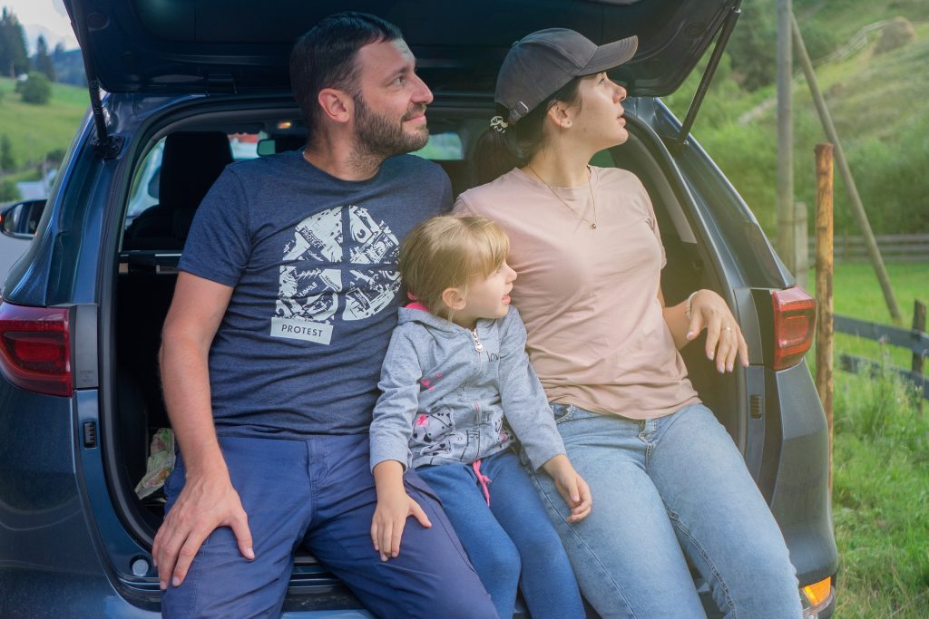 a young family sitting in a family car