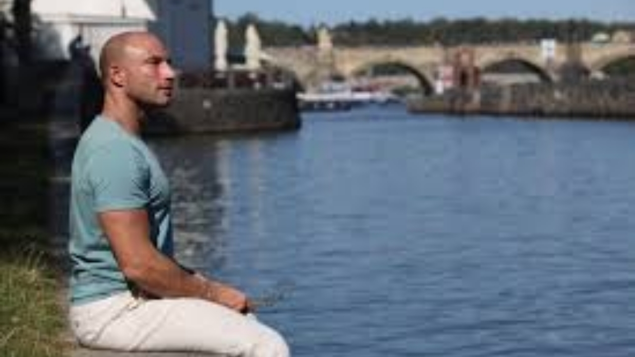 Pascal Bachmann enjoying a peaceful moment by the river, embracing mindfulness and self-reflection. Let me know if you want any refinements!