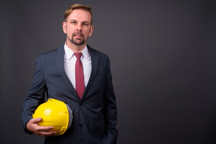 blond-bearded-businessman-with-goatee-holding-hardhat_251136-15815