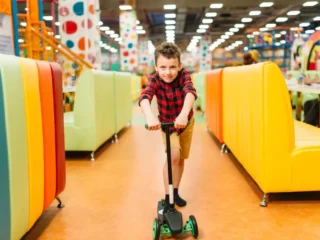 imgi_1_active-boy-riding-a-scooter-on-playground-PHJQ8DF-1024×684-1