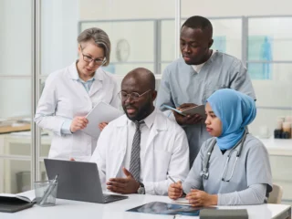 doctors-collaborating-around-laptop-in-modern-offi-2026-01-08-00-15-36-utc