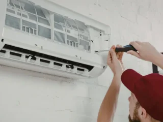 HVAC-technician-performing-AC-repair-on-a-central-air-conditioning-system-at-a-Massachusetts-home
